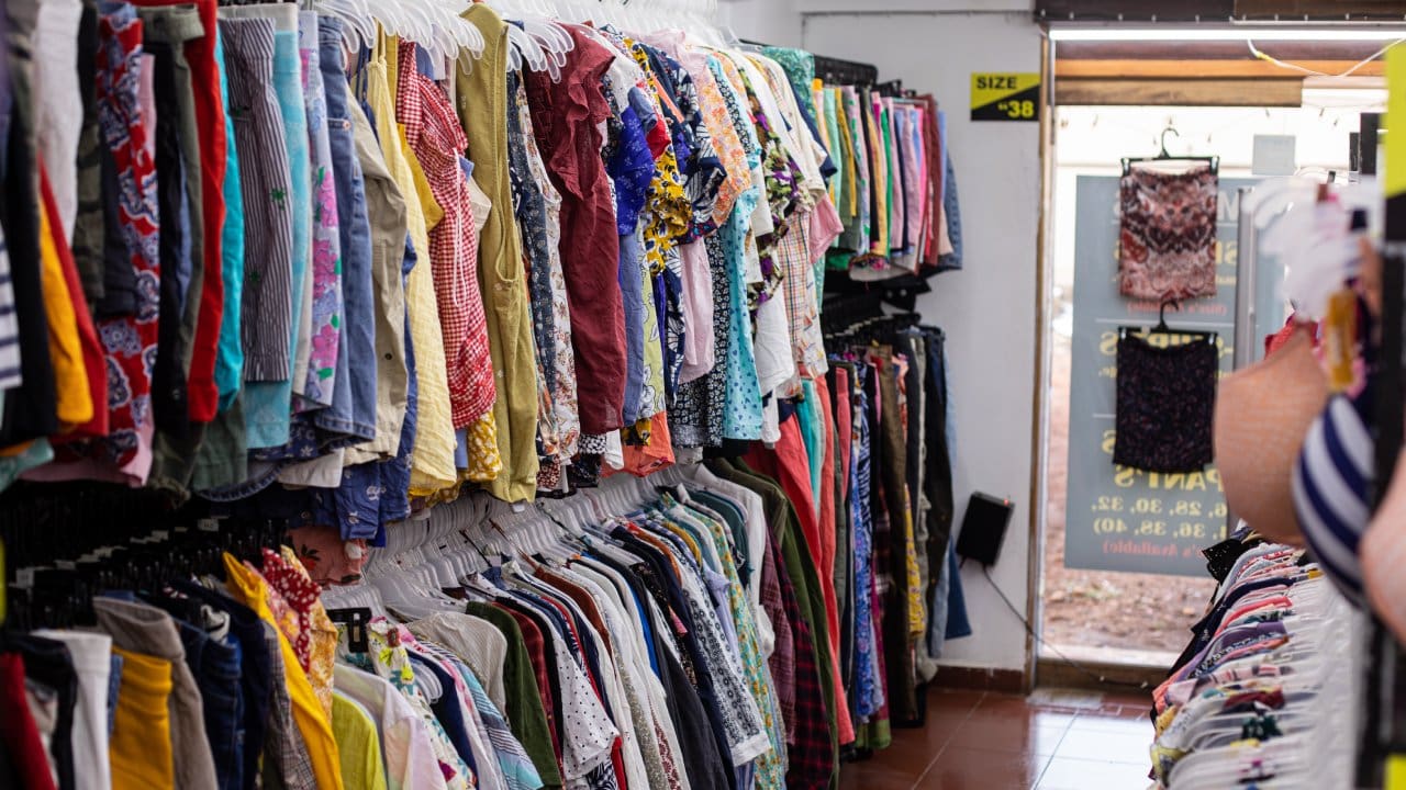 Colorful clothing racks in a shop.