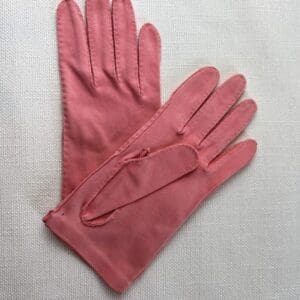 Pair of soft pink winter gloves on a white background.