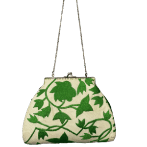 Vintage-style handbag with green vine pattern and gold chain strap.