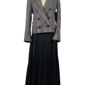 A plaid double-breasted blazer paired with a long black pleated skirt.