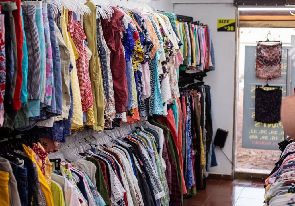 Colorful clothing racks in a shop.
